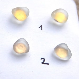 Gold-coloured earrings with white sea glass