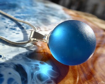 Pendant made of blue sea glass ball and 925 silver loop