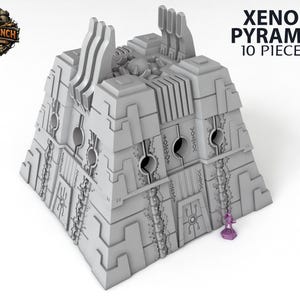 May include: A gray, geometric Xenos Pyramid model with the text "Xenos Pyramid 10 Pieces." The model has detailed architectural features, including circular openings and intricate patterns. A small purple figure stands beside the pyramid, suggesting scale. The Terrain Trench logo is in the upper left.