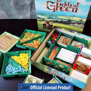 May include: Green and brown board game organizer insert with compartments for game pieces, cards, and rule books. The insert is labeled "Fields of Green" and is an official licensed product.