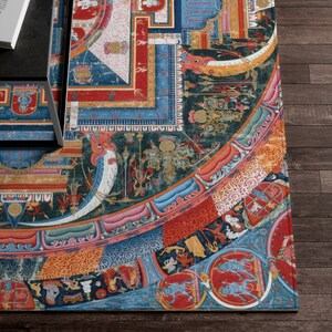 May include: A colorful mandala rug with intricate patterns and designs. The rug features a circular design with a central square and a variety of colors, including red, blue, green, and gold. The rug is made of a soft, durable material and is perfect for adding a touch of bohemian style to any room.