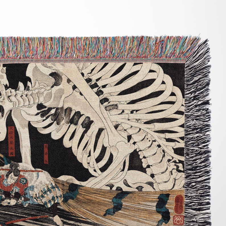 a tapestry with a skeleton and a cat on it