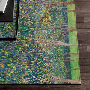 May include: A colorful abstract rug with a green, blue, and yellow pattern. The rug features a design of trees and leaves.