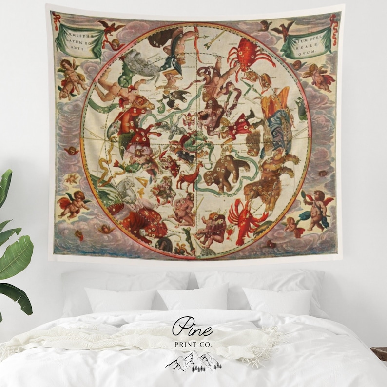 May include: A vintage tapestry featuring a circular illustration of the constellations. The tapestry is cream-colored with a light pink background and features a variety of celestial figures in red, orange, and yellow.