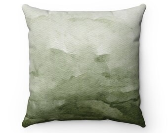 May include: A green watercolor throw pillow with a soft, abstract design. The pillow is made of a soft, comfortable fabric and is perfect for adding a touch of color and style to any room.