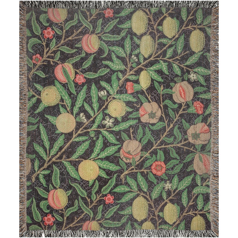 May include: A woven throw blanket with a repeating pattern of pomegranates, lemons, and leaves on a dark background. The pattern is in shades of green, red, yellow, and brown.