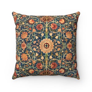 Pode incluir: Uma almofada decorativa com fundo azul e um padrão floral em tons de laranja, vermelho e verde.
