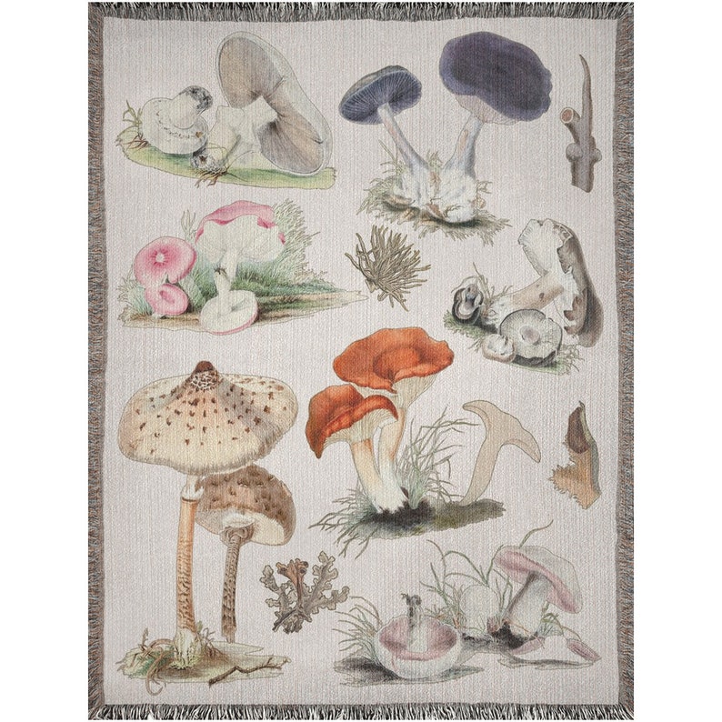 May include: A woven tapestry featuring a variety of mushrooms in different colors and shapes, including red, brown, white, and purple. The mushrooms are depicted against a light beige background with green foliage.