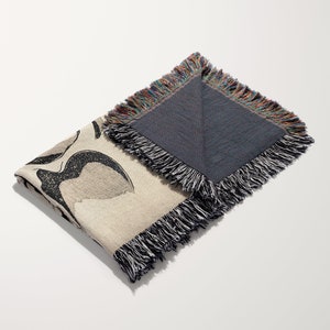 a black and white scarf with a bird on it