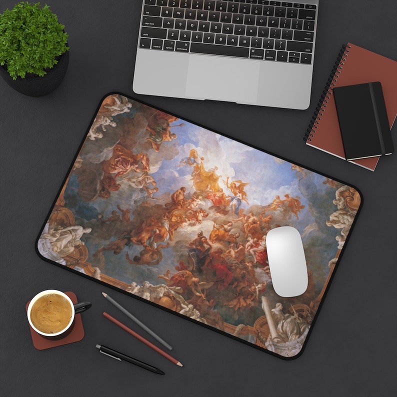 May include: A mouse pad featuring a detailed reproduction of a Renaissance-era painting depicting a scene of angels and figures in the clouds. The painting is in shades of blue, white, gold, and red.