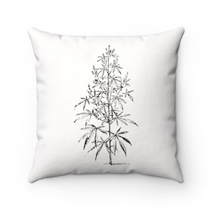 May include: Black and white line drawing of a cannabis plant on a white pillow.