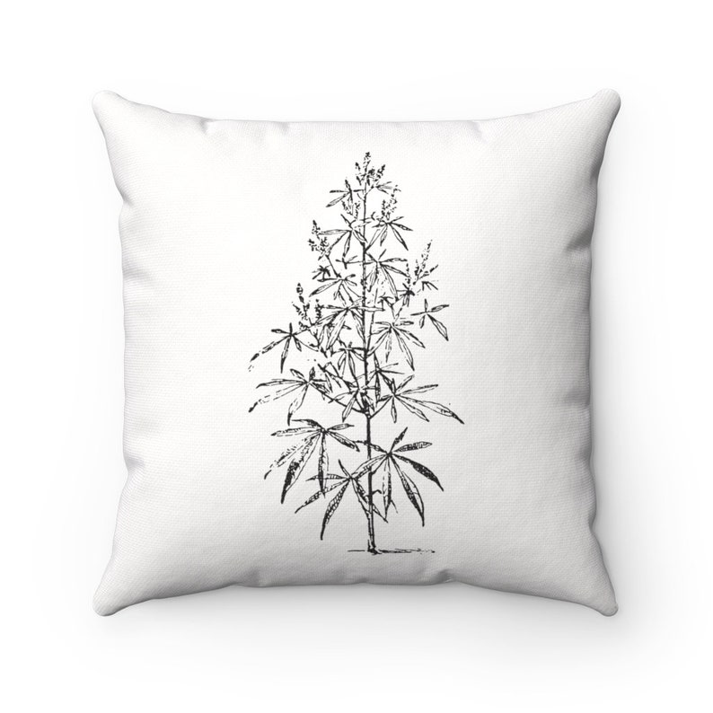 May include: Black and white line drawing of a cannabis plant on a white pillow.