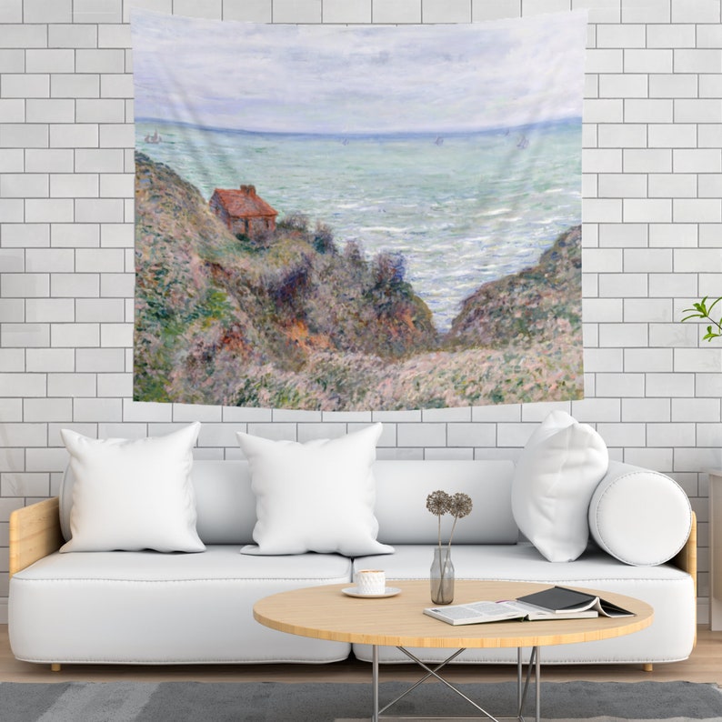 May include: A tapestry featuring a painting of a small red house on a cliff overlooking a blue ocean with whitecaps. The sky is a light blue with white clouds. The painting is in a painterly style with visible brushstrokes.