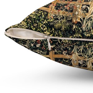 May include: A throw pillow with a zipper closure. The pillow features a tapestry-style design with a black background and intricate floral patterns in shades of green, red, and gold.