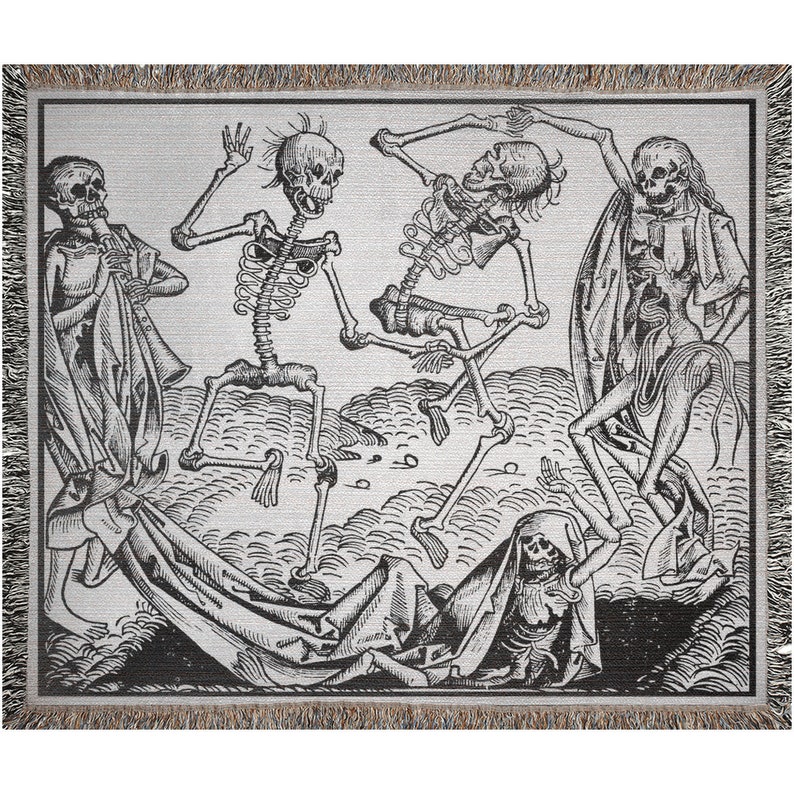 May include: A woven throw blanket featuring a black and white illustration of dancing skeletons. The artwork depicts several skeletons in various poses, with detailed shading and a textured background. The blanket has a fringed border.