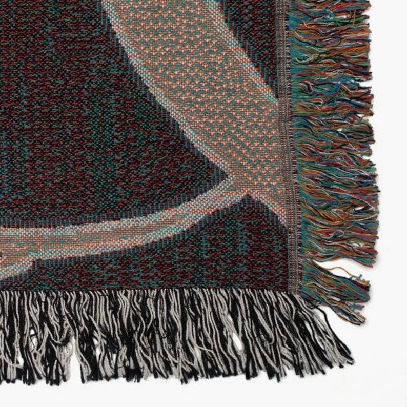 a multicolored rug with fringes on a white background