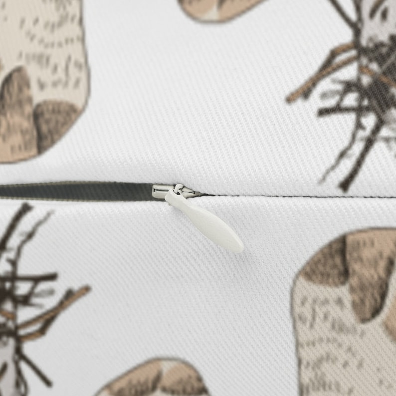 May include: A white pillow with a zipper closure. The pillow has a pattern of brown and white dogs with a twig design.