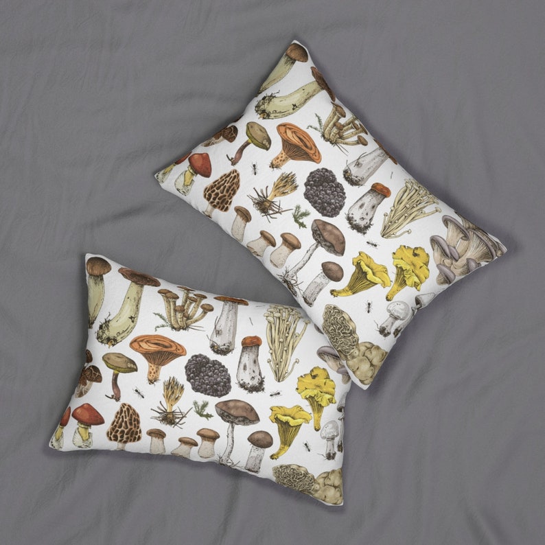 May include: Two white pillowcases with a mushroom pattern. The pillowcases feature a variety of mushrooms in different colors and sizes, including brown, white, yellow, and red. The mushrooms are drawn in a realistic style.