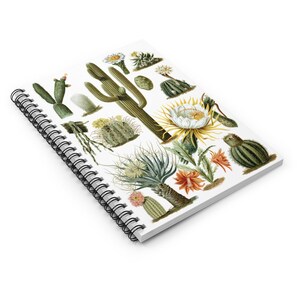 以下が含まれることがあります： 様々なサボテンと砂漠の花のカラフルなイラストが描かれた白いスパイラルバインディングノート。イラストには、緑、茶色、白、黄、オレンジ、赤の色が含まれています。