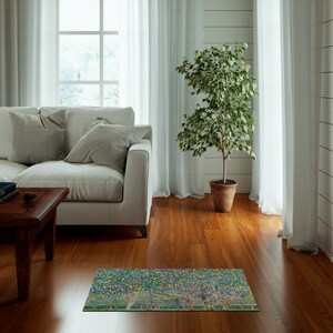 May include: A green, yellow, and blue patterned rug with a design of trees. The rug is placed on a hardwood floor in a living room setting.