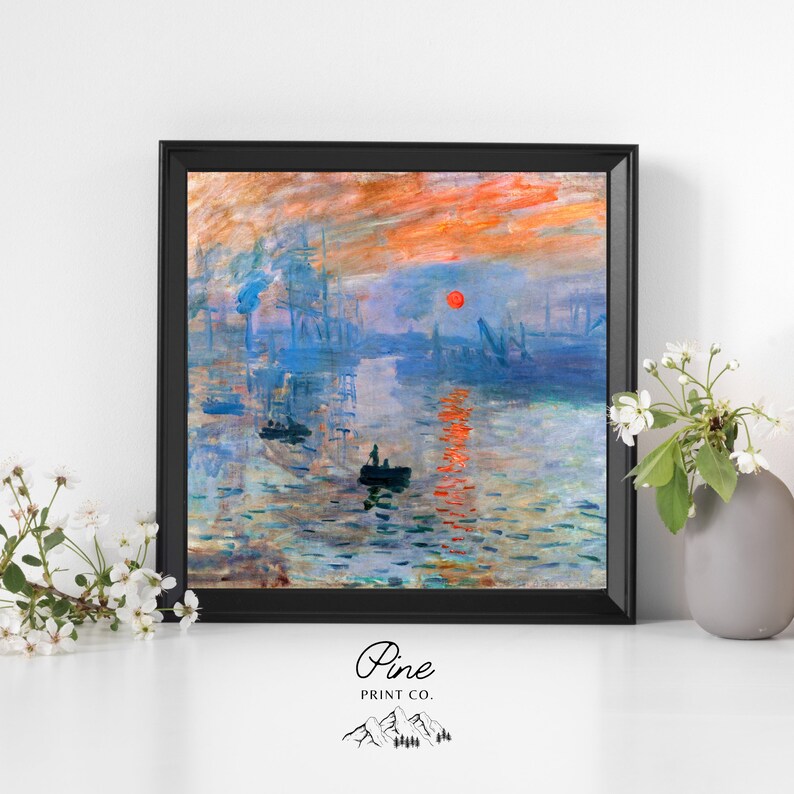 May include: A framed painting of a seascape with a red sun setting over the water. The painting is in a black frame and is set against a white wall.