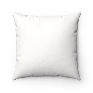 May include: A white square pillow with a smooth, soft fabric surface.