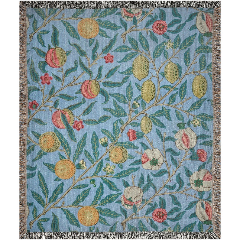 May include: A woven throw blanket with a blue background and a repeating pattern of lemons, oranges, and flowers. The pattern is in shades of green, yellow, orange, and pink.