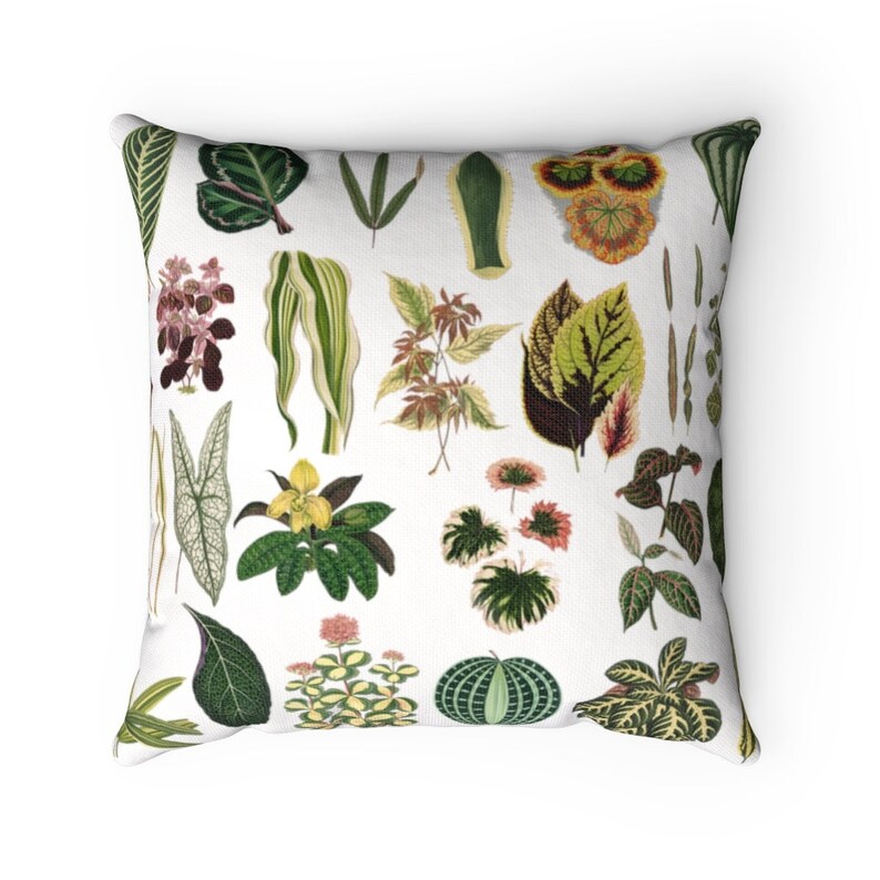 May include: A white throw pillow with a colorful pattern of various green, yellow, red, and brown leaves and flowers. The pillow is perfect for adding a touch of nature to any room.