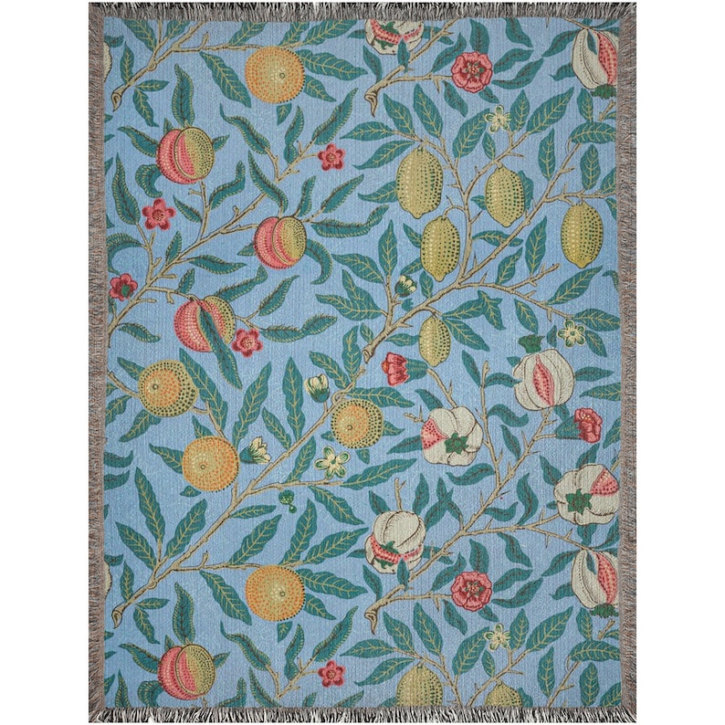 May include: A woven throw blanket with a blue background and a repeating pattern of green leaves, yellow lemons, and pink and white flowers.
