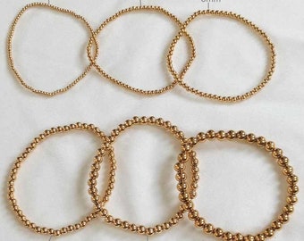 Bracelets perles élastiques acier inoxydable dorés / argentés femme