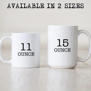 May include: Two white ceramic mugs with black text. The smaller mug is 11 ounces and the larger mug is 15 ounces.
