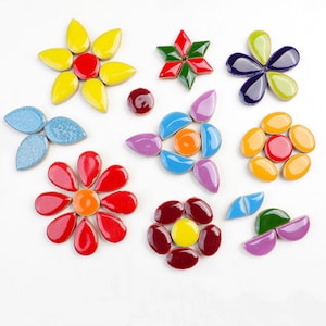 May include: Assortment of colourful ceramic flower-shaped mosaic tiles. The tiles are in various shapes and sizes, including leaves, petals, and circles. The colours include red, yellow, blue, green, purple, and orange.