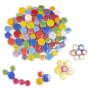 May include: A selection of colourful, round glass mosaic tiles in various sizes and shades. The tiles are in shades of red, blue, yellow, green, purple, and white. Some tiles have an iridescent finish, and are arranged in small groups.