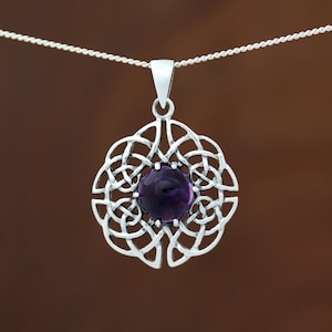 May include: A silver Celtic knot pendant featuring a purple amethyst gemstone in the centre.