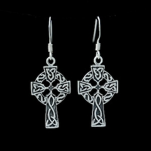 May include: A pair of silver Celtic cross earrings with intricate knotwork designs. The earrings have a drop style and are made of sterling silver.