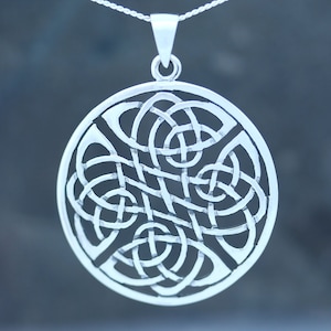 May include: Silver Celtic knot pendant necklace with a circular design. The pendant features a detailed intricate knot pattern.