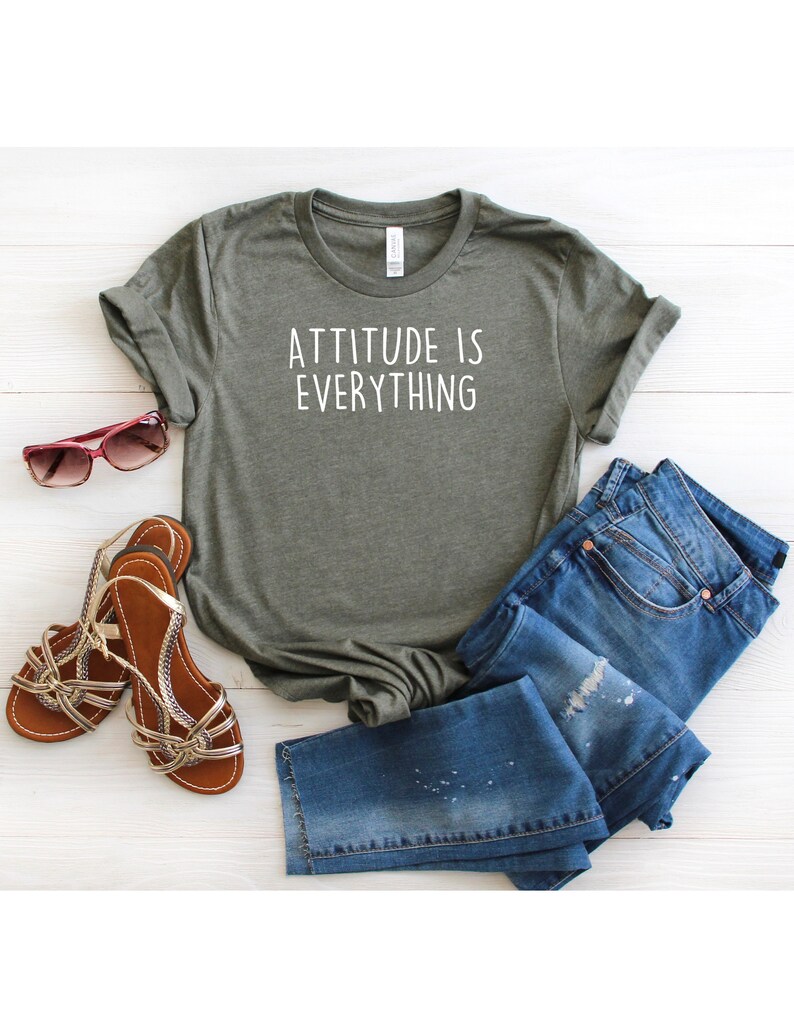 May include: A green t-shirt with the text "ATTITUDE IS EVERYTHING" in white lettering.