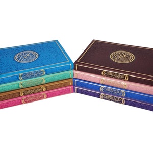 May include: A stack of ten colourful hardback books with gold lettering and a decorative design on the front cover. The books are arranged in a rainbow pattern, with the top book being blue and the bottom book being purple.