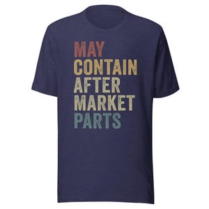 May include: A navy blue t-shirt with a vintage-style graphic that reads "MAY CONTAIN AFTER MARKET PARTS".