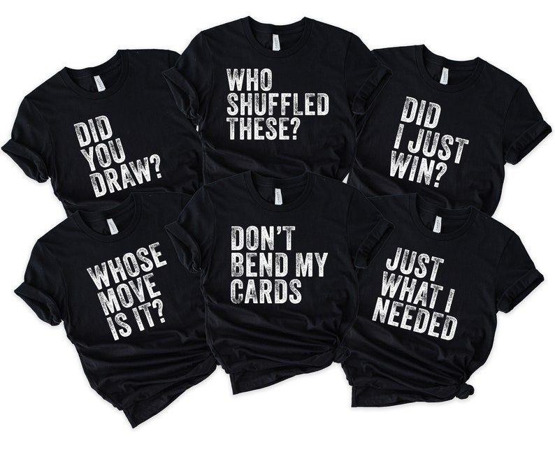 May include: Six black t-shirts with white text. The shirts have different phrases printed on them, including "Did you draw?", "Whose move is it?", "Who shuffled these?", "Don't bend my cards", "Did I just win?", and "Just what I needed."