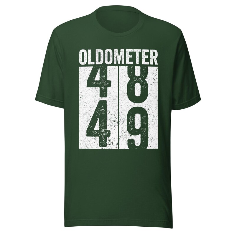 May include: Dark green t-shirt with the word "OLDOMETER" above the numbers 48 and 49 in a white, distressed font. The shirt is a short-sleeved crew neck.