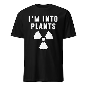May include: Black t-shirt with white text that reads "I'm into plants" and a white radiation symbol.
