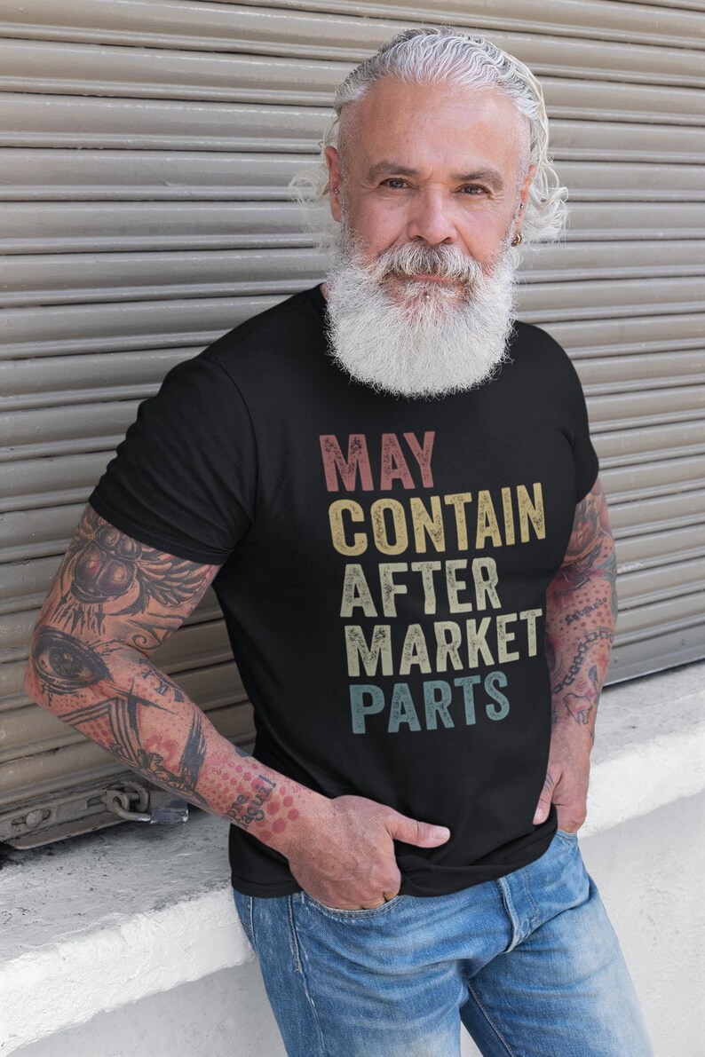 May include: A black t-shirt with a vintage-style graphic that reads "MAY CONTAIN AFTER MARKET PARTS".