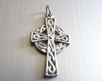 May include: A silver Celtic cross pendant with intricate knotwork design.