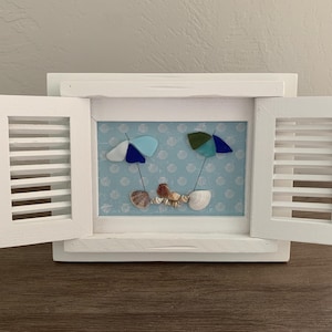Sea glass beach umbrella and sea shell framed art; white shutter frame