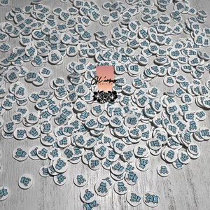 May include: A large quantity of white round stickers with a blue cartoon bear design.