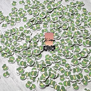 May include: A large quantity of small, white, round stickers with a green cartoon turtle design.