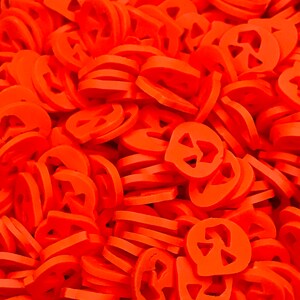 May include: A large pile of orange pumpkin-shaped confetti with a jack-o'-lantern face cut out.