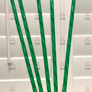 May include: Five green twisted drinking straws.
