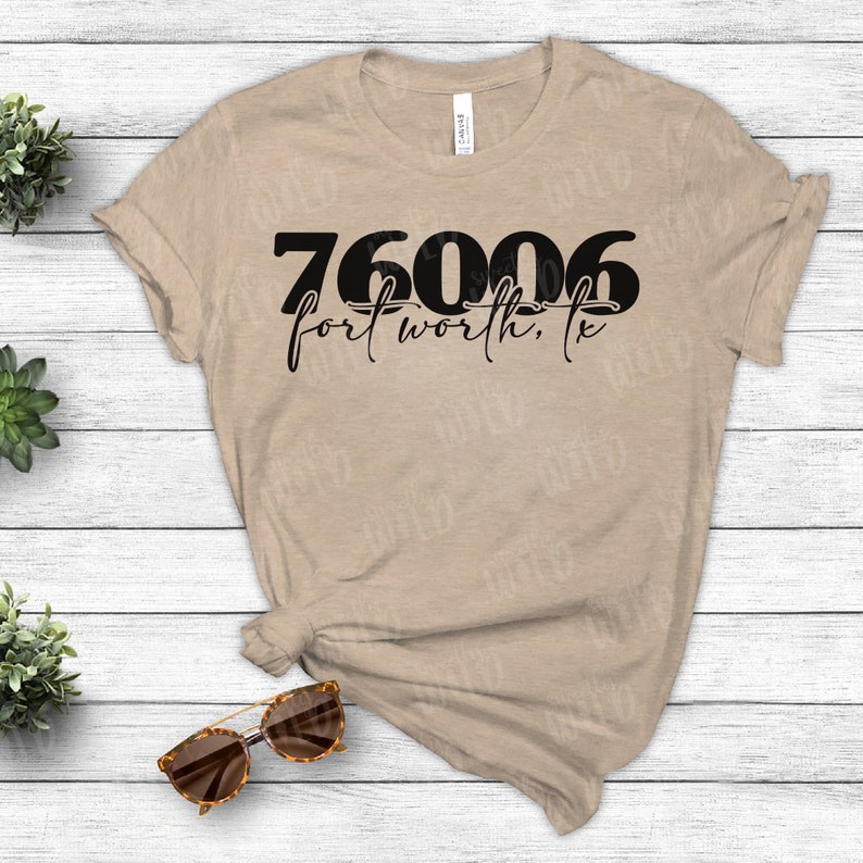 May include: A tan t-shirt with black text that reads "76006 fort worth, tx".